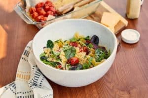 bowtie pasta salad with cherry tomato and cheese background