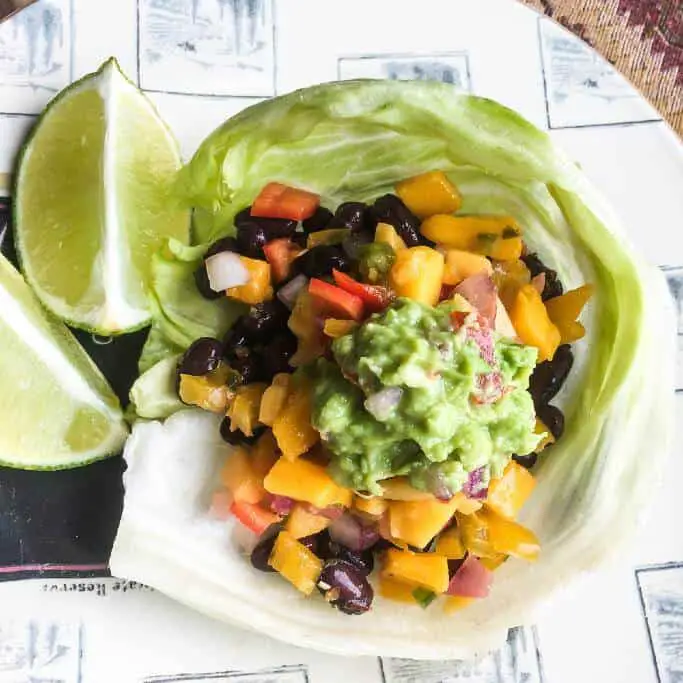 Black bean taco wrap with lime wedges