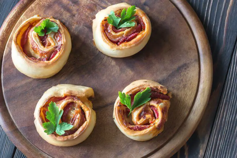 pizza rolls on wooden plate