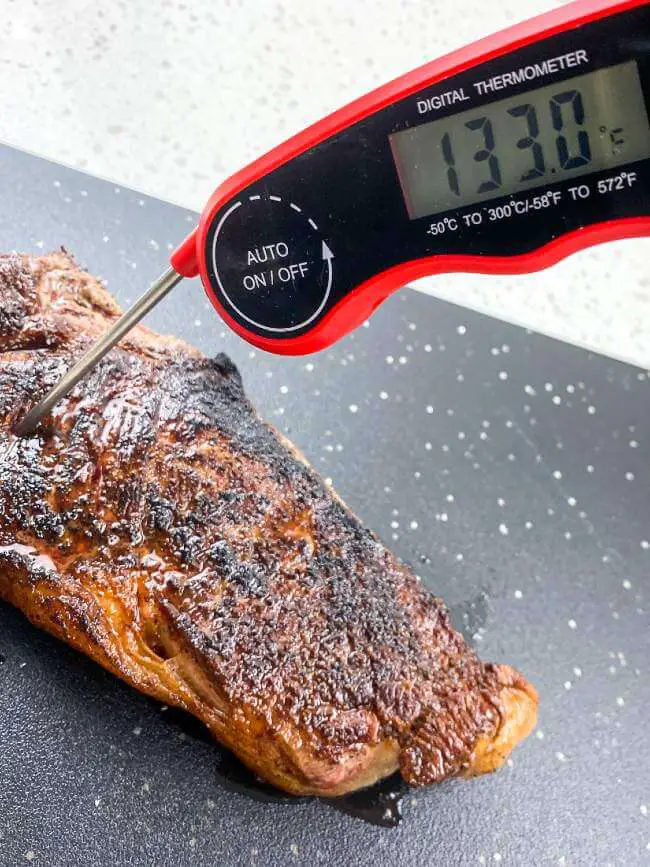 checking steak doneness with thermometer 