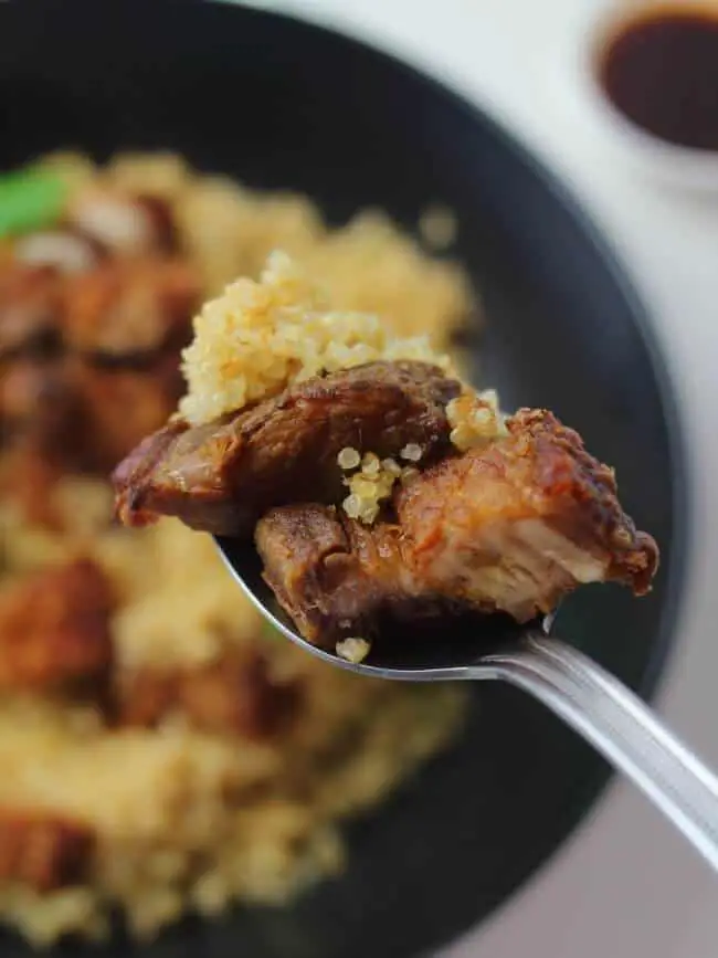 crispy pork belly and rice on spoon