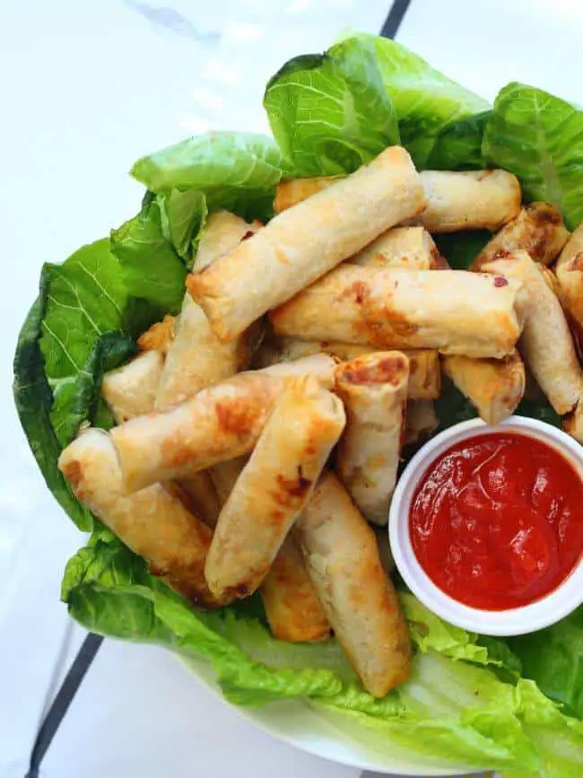 Cooked egg rolls with sauce