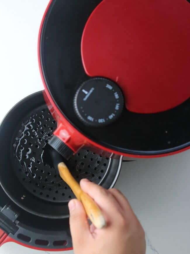 Brushing air fryer with oil