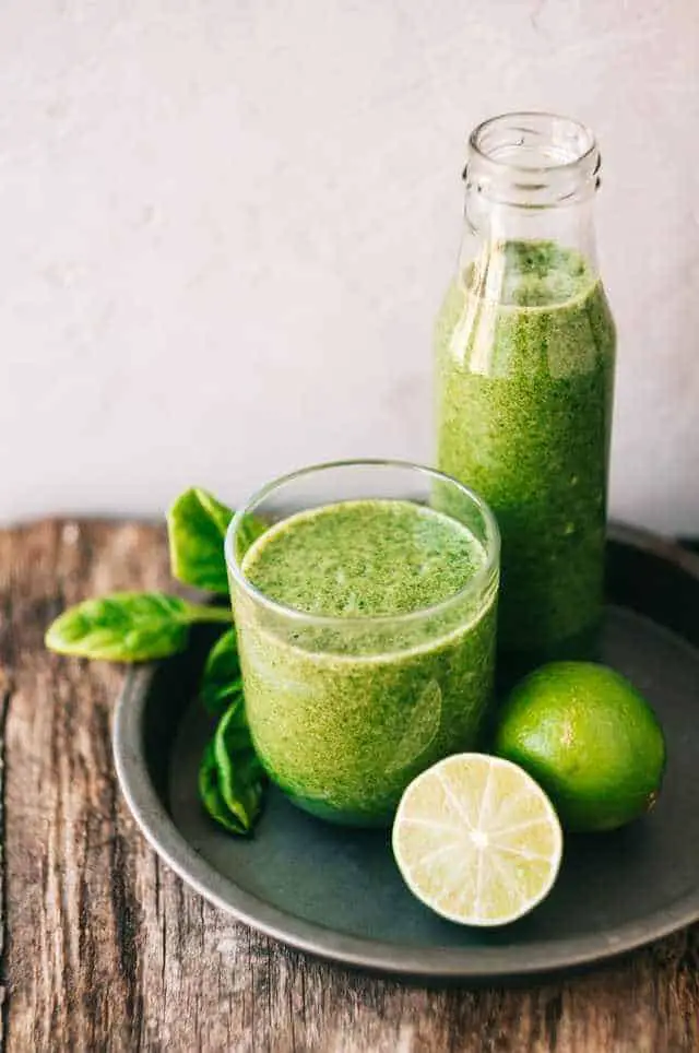 glass of green smoothie and lime