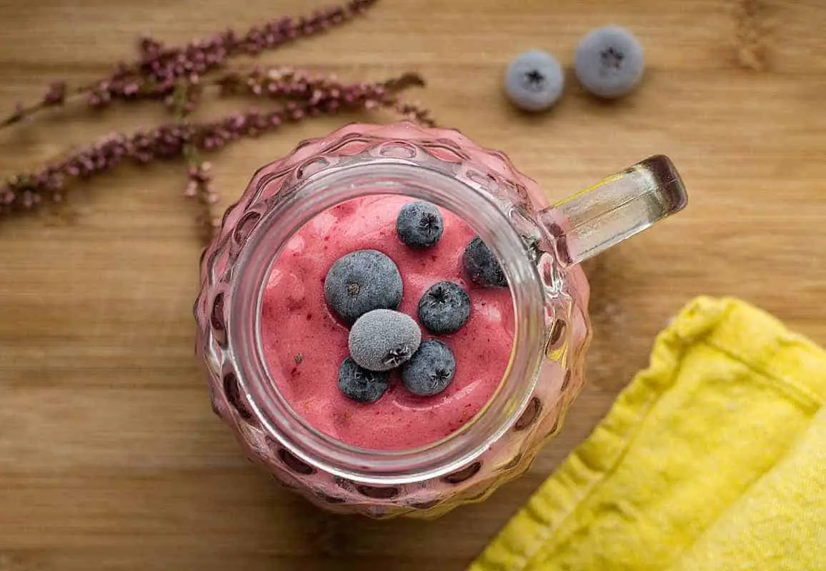 pink berry smoothie with fresh blueberries