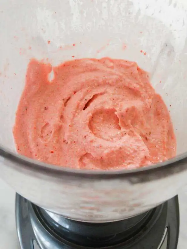 tasty pink fruit shake in blender container