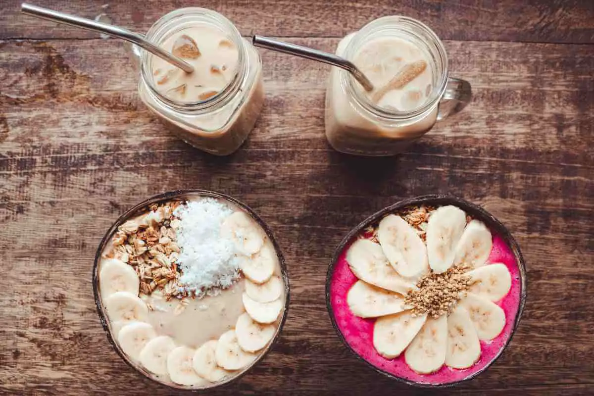 healthy banana smoothie bowl with drinks