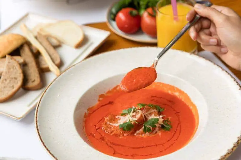 tomato soup served on white plate