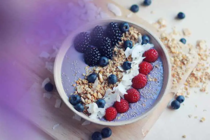 purple fruit smoothies topped with berries