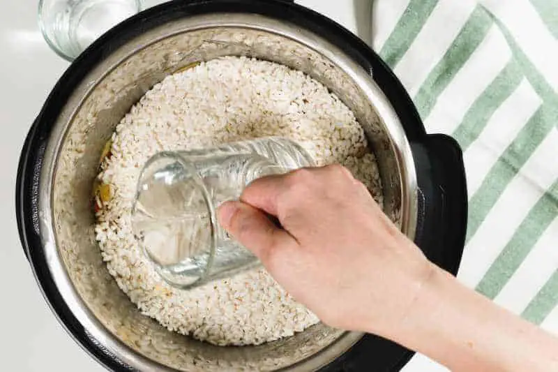 pouring water to a rice cooker