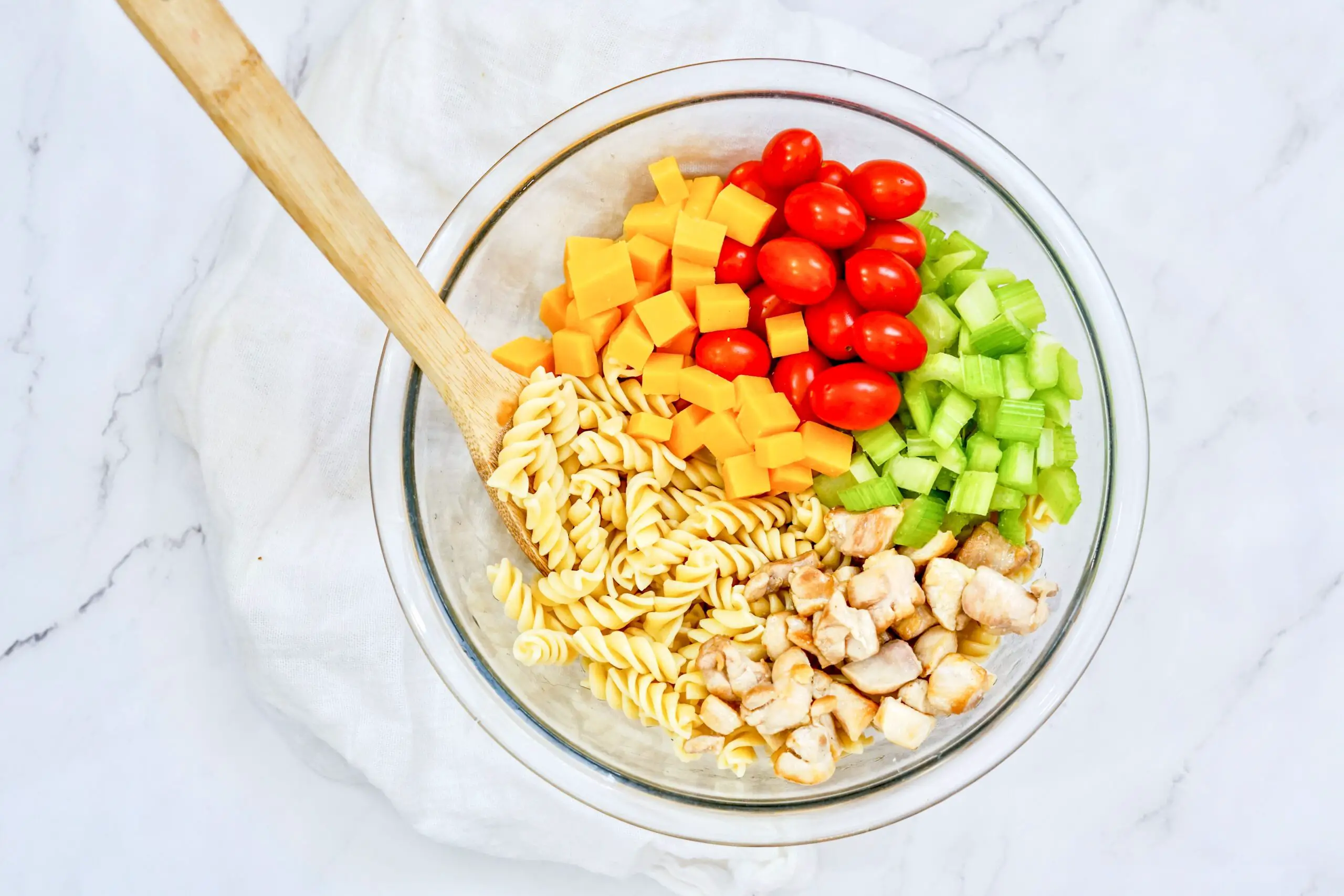 Toss chicken, noodles, cheese, celery, and tomatoes together.
