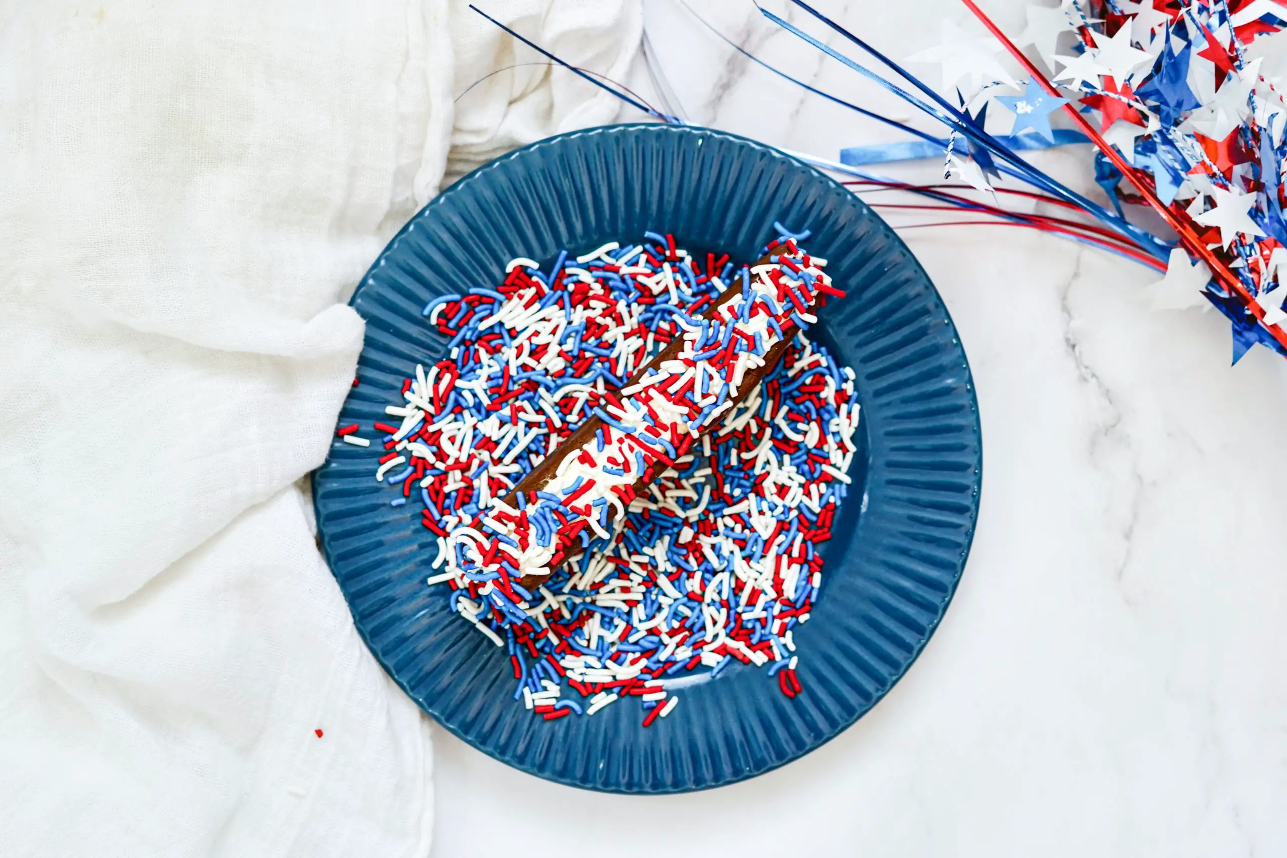 Dip the ice cream sandwich in the patriotic sprinkles.