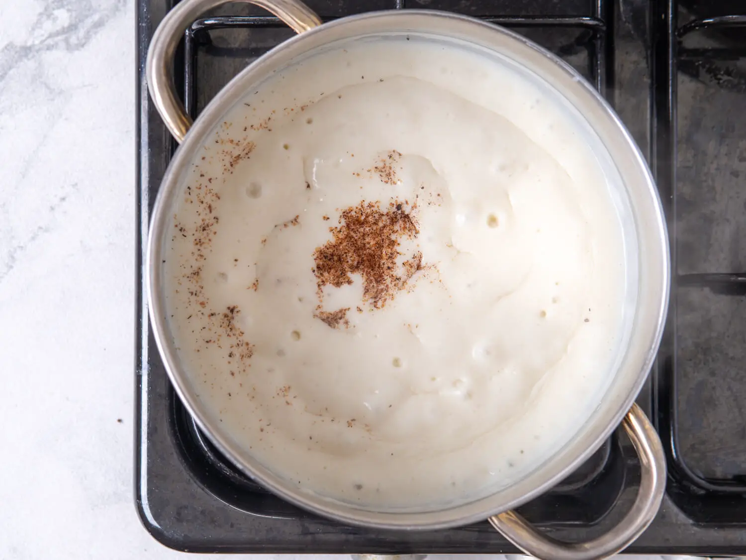 Raise the heat to medium-high and whisk in the milk gently until it has thickened and incorporated.